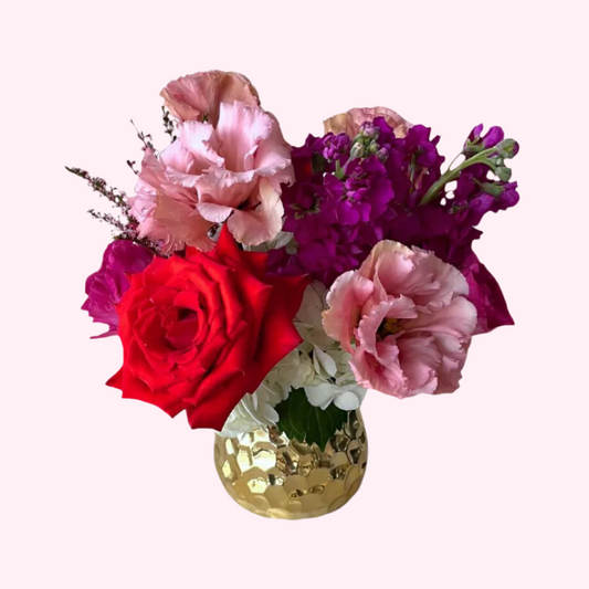 A fun mix of colorful and vibrant blooms that change daily and weekly upon seasonal availability. Flowers and vases vary.